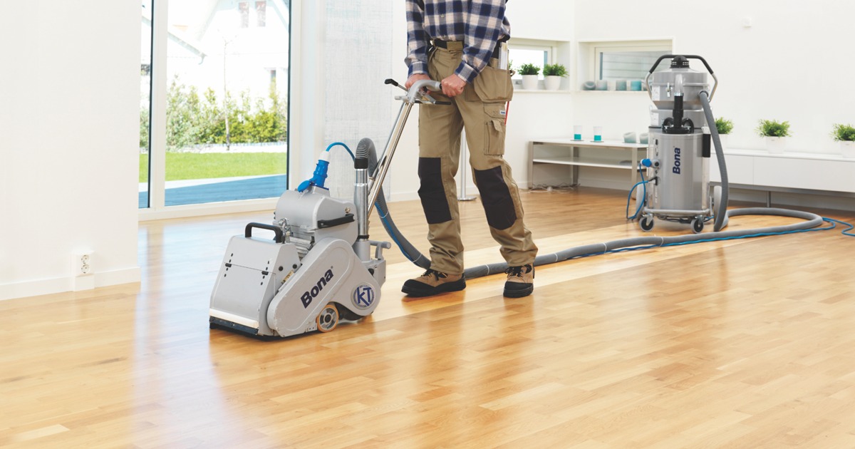 Commercial Floor Sanding in Egham on an oak hardwood plank floor using a dust-free sanding machine in a bright commercial space.